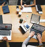 People sitting on table with laptop and discussing.